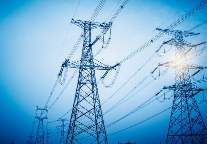 High voltage towers with sky background.
