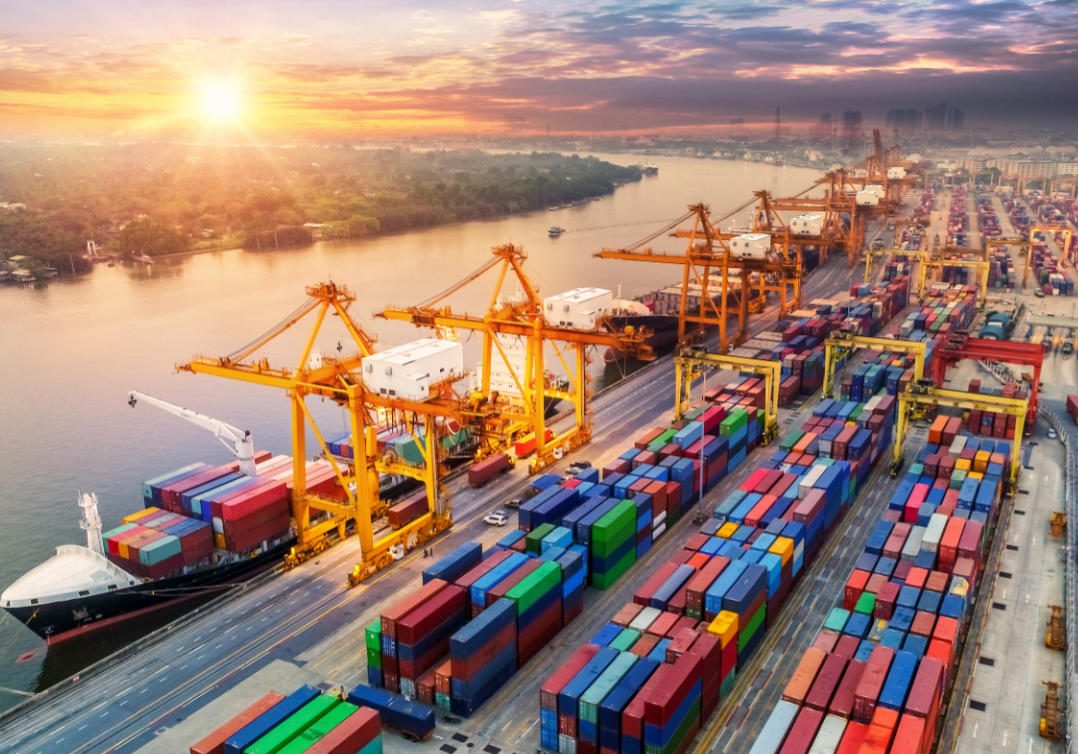 Logistics and transportation of Container Cargo ship and Cargo plane with working crane bridge in shipyard at sunrise, logistic import export and transport industry background